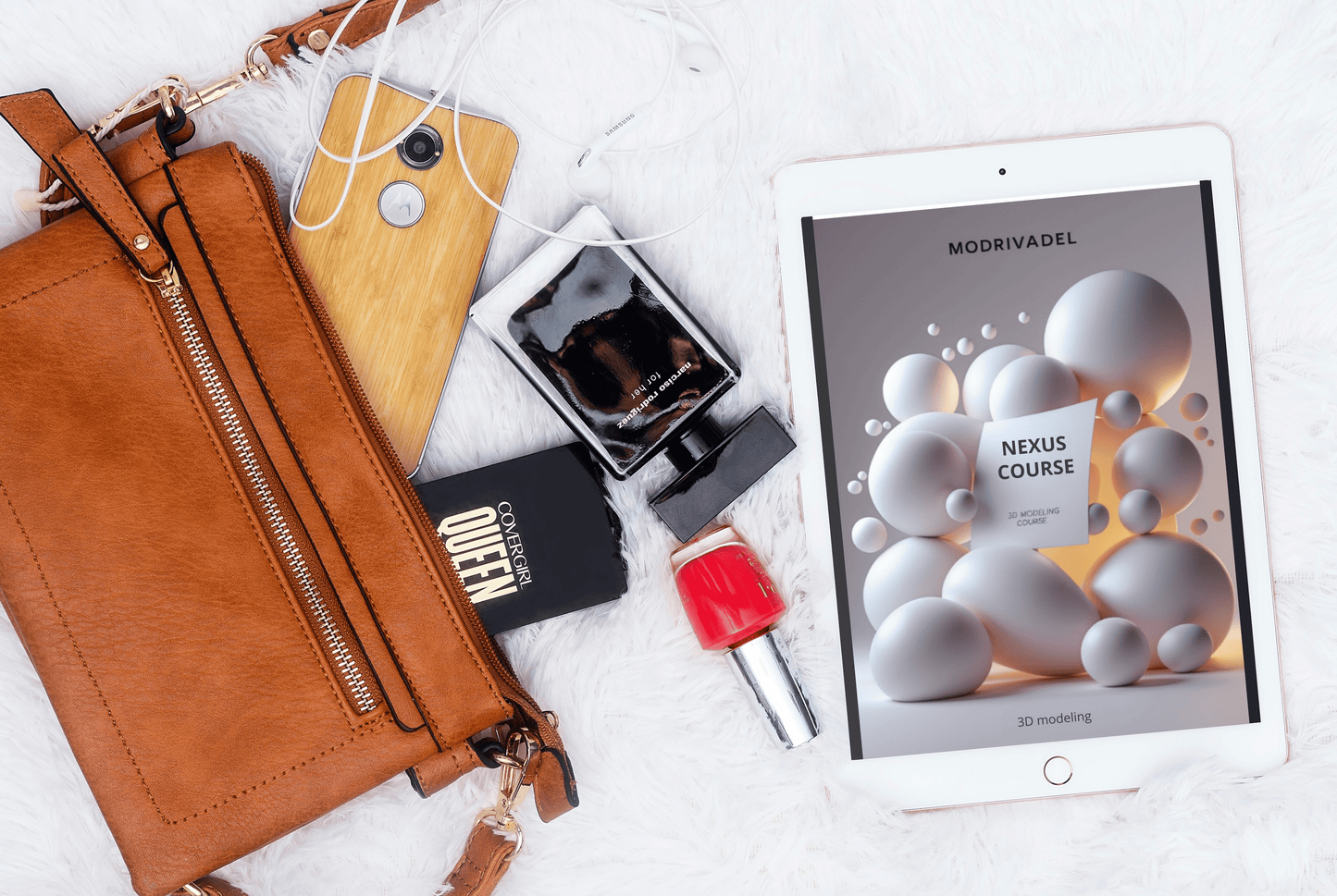 Brown leather wallet, phone, perfume bottle, nail polish, and tablet with a course on a white surface