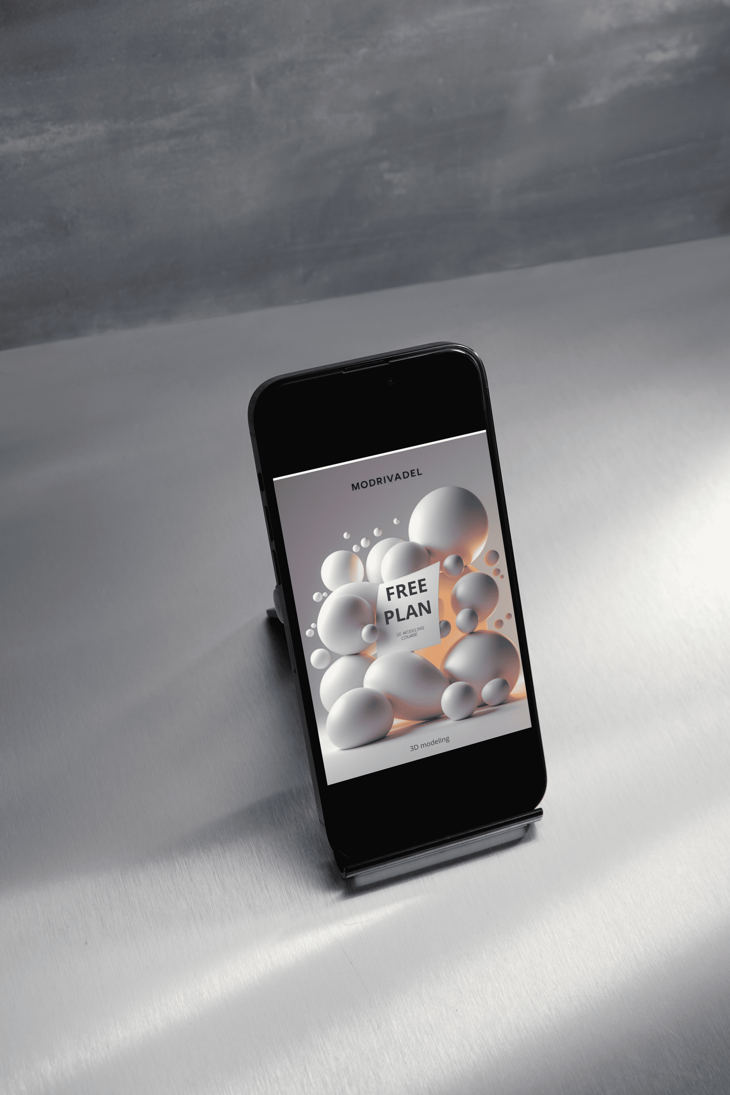 Smartphone with a free plan offer on the screen, placed on a white surface with a gray background.